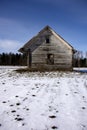 Wooden historical barn on winter field