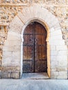 Old wooden arched doorway in historic spain Royalty Free Stock Photo