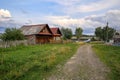 Old wooden house with barn in the ancient village of Visim, Sverdlovsk region, Urals, Russia Royalty Free Stock Photo