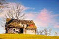 Old wooden house built on grassy hill against mountains Royalty Free Stock Photo