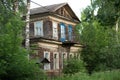 Old wooden two-storey house in russian provincial town at sunset