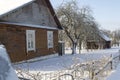 Old wooden house covered with fresh fallen snow. Uninhabited old winter cozy cottage in empty village. Rural wintertime Royalty Free Stock Photo