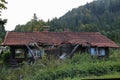 Old wooden house in disrepair on the edge of the village Royalty Free Stock Photo