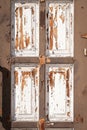 Old wooden house door detail. Weathered, aged, shabby, vintage entrance in sunshine. Peeled off paint Royalty Free Stock Photo