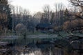 Old wooden house on the edge of forest near the lake in spring season. Fishing village. Traditional exterior in soviet or russian Royalty Free Stock Photo