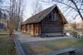 Old wooden house on the edge of forest near the lake in spring season. Fishing village. Traditional exterior in soviet or russian Royalty Free Stock Photo