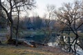 Old wooden house on the edge of forest near the lake in spring season. Fishing village. Traditional exterior in soviet or russian Royalty Free Stock Photo