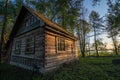 Old wooden house on the edge of forest near the lake Svir at sunrise