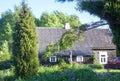 The old wooden house and garden plants in the village