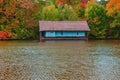 The old wooden house on the lake in the autumn season Royalty Free Stock Photo