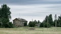 Old wooden house in the meadow. Stone foundation. Rural landscape Royalty Free Stock Photo