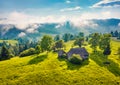 Old wooden house on the mountain valley. Misty summer scene of abandoned Carpathian village. Royalty Free Stock Photo