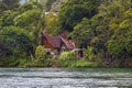 Old wooden house in a traditional Indonesian style with a fishing boat stands in a tropical forest Royalty Free Stock Photo