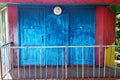 Old wooden house with two blue doors Royalty Free Stock Photo