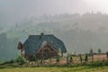 Old wooden house under rain in mountain. cheese dairy. Carpathians, Ukraine. Royalty Free Stock Photo