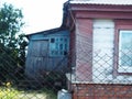 An old wooden house with a veranda in a Russian village. A remote area Royalty Free Stock Photo