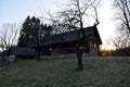 Old wooden house in the village on a background of trees in the garden sunset background in spring or autumn season. Fishing Royalty Free Stock Photo