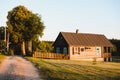 Old wooden house in village. National wooden farmhouse in Belarus. View of rustic ethnic house on sunset. Rural landscape Royalty Free Stock Photo