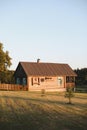 Old wooden house in village. Farmhouse in Belarus. View of rustic ethnic house on sunset. rural landscape Royalty Free Stock Photo