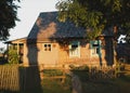 Old wooden house in village. Farmhouse in Belarus. View of rustic ethnic house on sunset. rural landscape Royalty Free Stock Photo