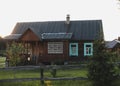 Old wooden house in village. Farmhouse in Belarus. View of rustic ethnic house on sunset. rural landscape Royalty Free Stock Photo