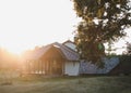 Old wooden house in village. Farmhouse in Belarus. View of rustic ethnic house on sunset. rural landscape Royalty Free Stock Photo