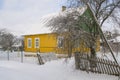 Old wooden house in village. Farmhouse in Belarus. View of rustic ethnic house in winter. Snowy rural landscape