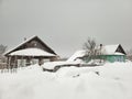 Old wooden house in the winter village, snow drifts, harsh nature Royalty Free Stock Photo