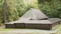 Old wooden house with wooden roof in the forest, background Royalty Free Stock Photo