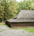 Old wooden house with wooden roof in the forest, background Royalty Free Stock Photo