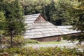 Old wooden house with wooden roof in the forest, background Royalty Free Stock Photo