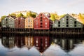 Old wooden houses on a row next to the river in the city of Trondheim. Royalty Free Stock Photo