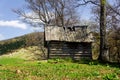 Old wooden hut cabin in mountain alps at rural fall landscape