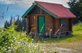 Old wooden hut cabin in mountain alps at rural summer landscape. Cozy wooden cabin in a forest Royalty Free Stock Photo