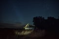 Old wooden hut in the countryside. night photo with starry sky.