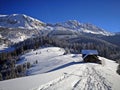 Old wooden hut in a mountains landscape during winter