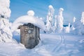 Old wooden hut in winter snowy forest in Finland, Lapland. Royalty Free Stock Photo