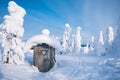 Old wooden hut in winter snowy forest in Finland, Lapland. Royalty Free Stock Photo