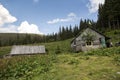 Old wooden huts on the Carpathian meadows, where sheep and cows graze Royalty Free Stock Photo