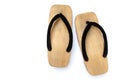 Old wooden Japanese sandal isolated on white background. It is a form of traditional Japanese footwear.