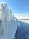 Old wooden jetty Tuja in Latvia by the Baltic Sea on a cold winter morning. Frozen pier, ice, snow Royalty Free Stock Photo