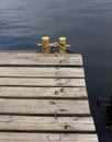 Old wooden jetty, yellow bitt with rope Royalty Free Stock Photo