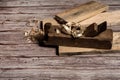 Old wooden jointer, boards and shavings on a wooden background. Royalty Free Stock Photo