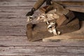 Old wooden jointer, hammer, chisel, saw-hacksaw with small teeth, boards and shavings on a wooden background. Royalty Free Stock Photo