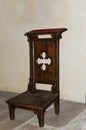 Old wooden kneeler  or prayer stool in a catholic church Royalty Free Stock Photo