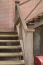 Old wooden ladder in the house with a handrail.