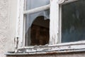 Old wooden lattice window with broken glass