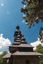 Old wooden Lemk church against a bright blue sky with clouds. Royalty Free Stock Photo