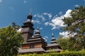 Old wooden Lemk church against a bright blue sky with clouds. Royalty Free Stock Photo