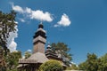 Old wooden Lemk church against a bright blue sky with clouds. Royalty Free Stock Photo